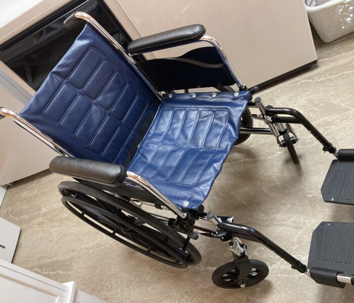 Chrome Invacare wheelchair with blue upholstery