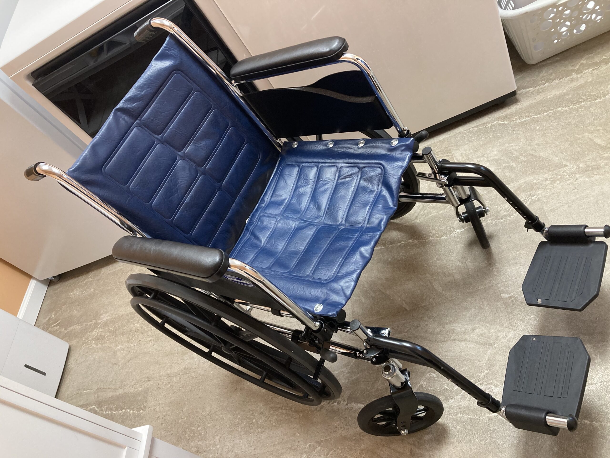 Chrome Invacare wheelchair with blue upholstery