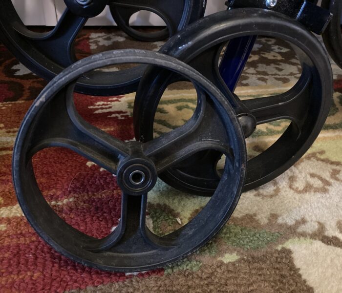 Comparison of a worn out rollator wheel and a new version of the same part.