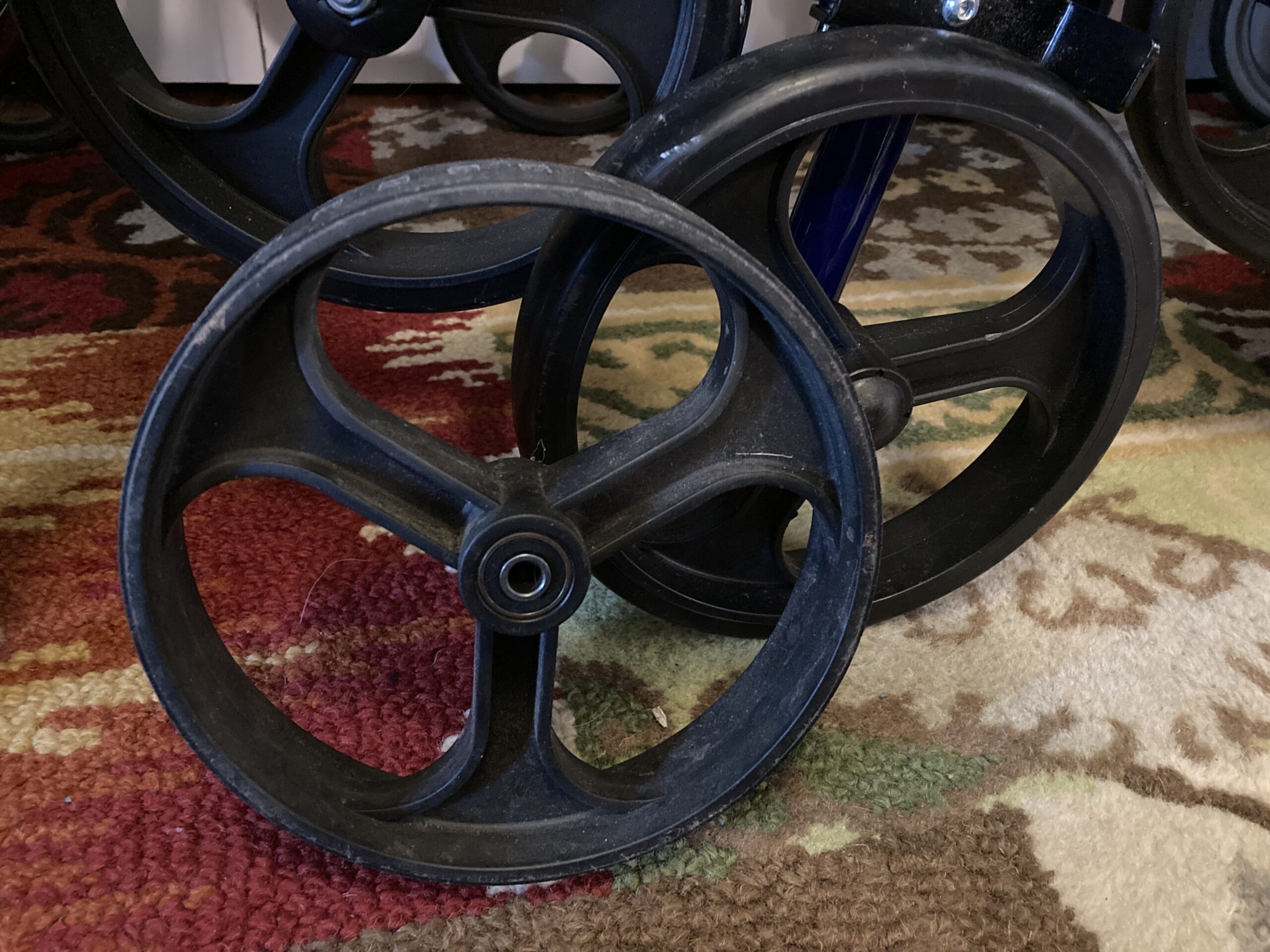 Comparison of a worn out rollator wheel and a new version of the same part.